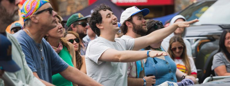 two men in the crowd look excitedly at the main stage as they dance to Billy Failing